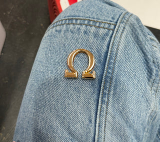 GOLD OMEGA SIGN